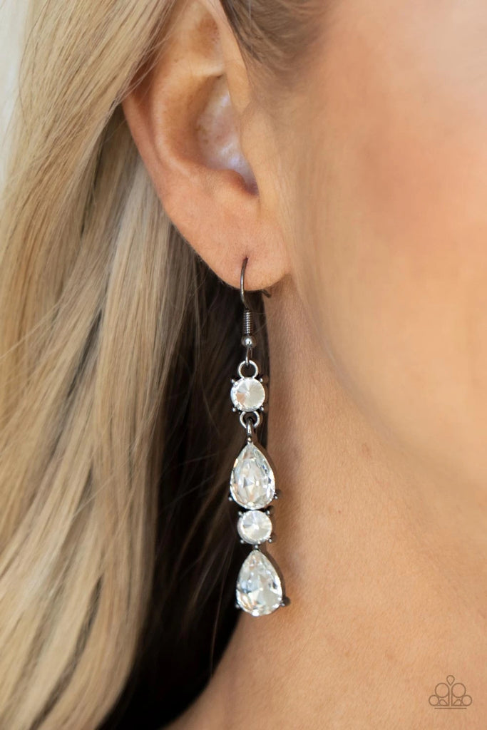 A glamorous collection of brilliant white teardrop and round rhinestones encased in classic gunmetal pronged fittings stack together creating an irresistibly refined lure. Earring attaches to a standard fishhook fitting.  Sold as one pair of earrings.