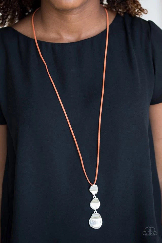 Delicately hammered in a glistening shimmer, asymmetrical silver frames link at the bottom of a lengthened orange suede strand for a bold artisanal look. Features an adjustable clasp closure. Sold as one individual necklace. Includes one pair of matching earrings.