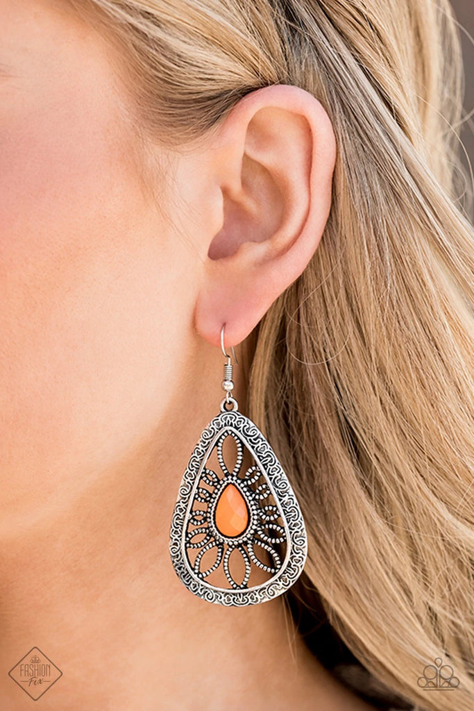 A dewy Orange Peel bead is pressed into the center of an oversized ornate silver teardrop frame studded and embossed in swirling filigree detail for a whimsical look. Earring attaches to a standard fishhook fitting.  Sold as one pair of earrings.