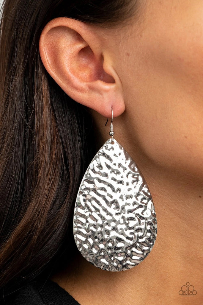 Hammered in a blinding finish, a rippling silver teardrop swings from the ear for a bold industrial flair. Earring attaches to a standard fishhook fitting.  Sold as one pair of earrings.