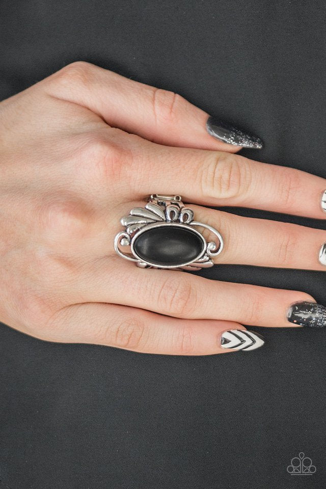 Chiseled into a smooth oval, an earthy black stone is pressed into the center of a glistening silver frame radiating with filigree detail for a seasonal look. Features a stretchy band for a flexible fit. Sold as one individual ring.