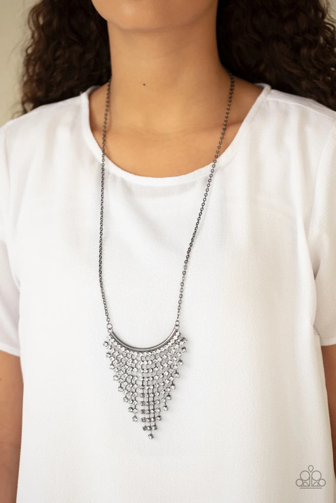Chains of glittery white rhinestones stream from the bottom of a bowing gunmetal bar, creating a tapered fringe at the bottom of a lengthened gunmetal chain. Features an adjustable clasp closure.  Sold as one individual necklace. Includes one pair of matching earrings.  