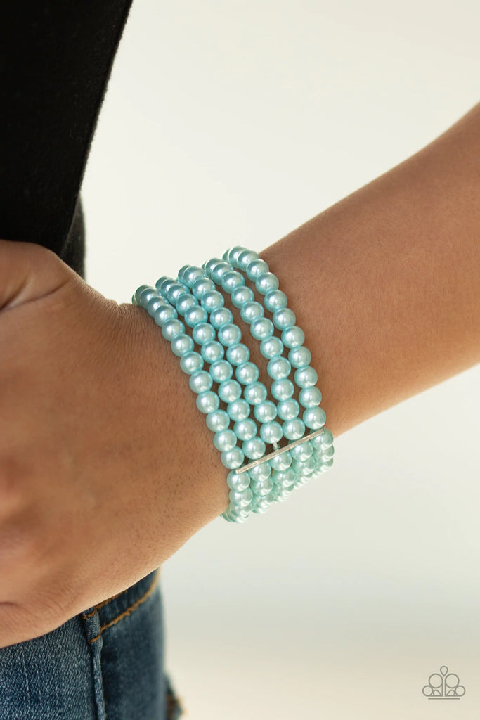 Threaded through glistening silver fittings, strand after strand of dainty blue pearls are threaded along stretchy bands around the wrist for a timelessly stacked look.  Sold as one individual bracelet.