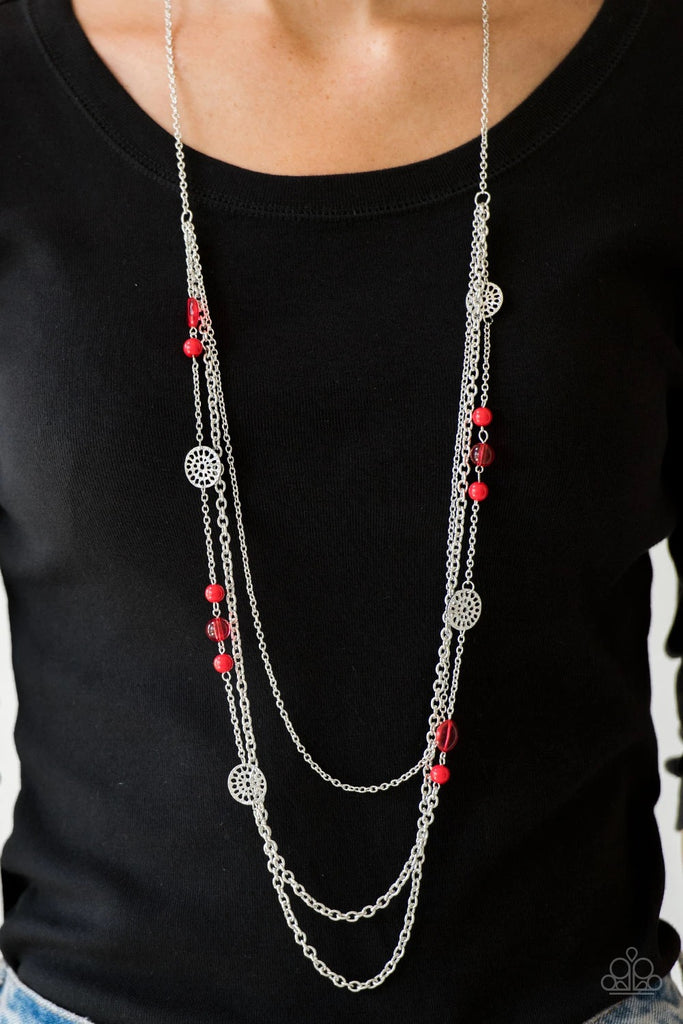 Ornate silver accents, glassy beads, and polished red beads trickle along strands of shimmery silver chains for a whimsical look. Features an adjustable clasp closure.  Sold as one individual necklace. Includes one pair of matching earrings.