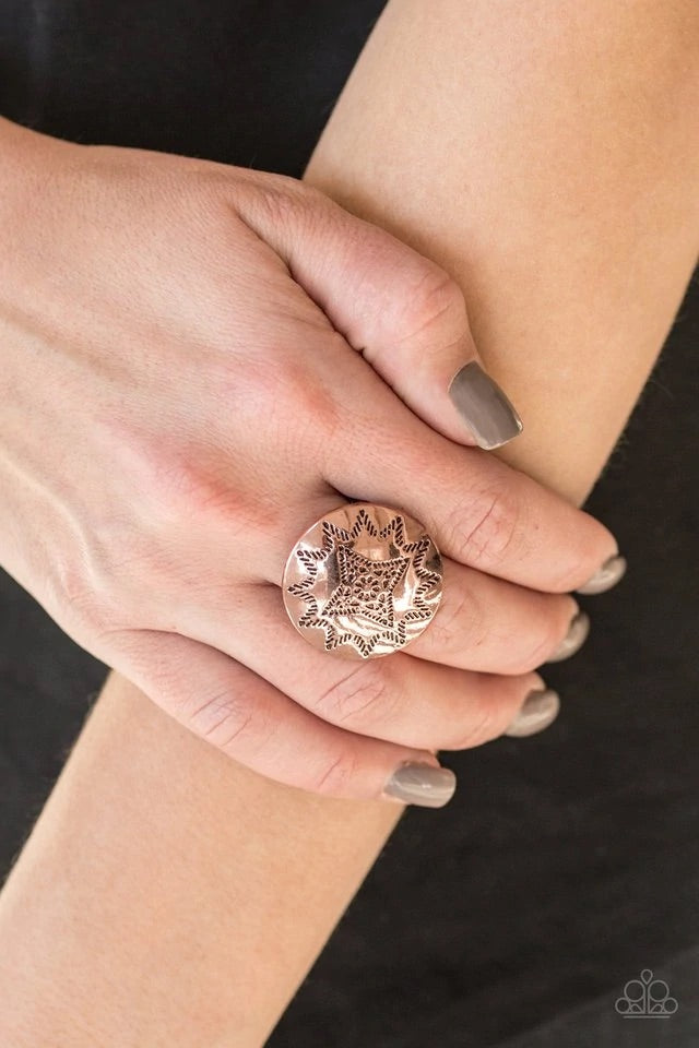 Dotted in a radiant sunburst pattern, a shiny copper frame spins atop the finger for a seasonal look. Features a stretchy band for a flexible fit. Sold as one individual ring.