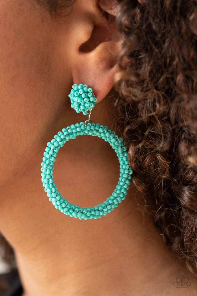 A refreshing collection of dainty turquoise seed beads are woven around a circular frame at the bottom of a matching beaded fitting, creating a colorful hoop. Earring attaches to a standard post fitting.  Sold as one pair of post earrings.