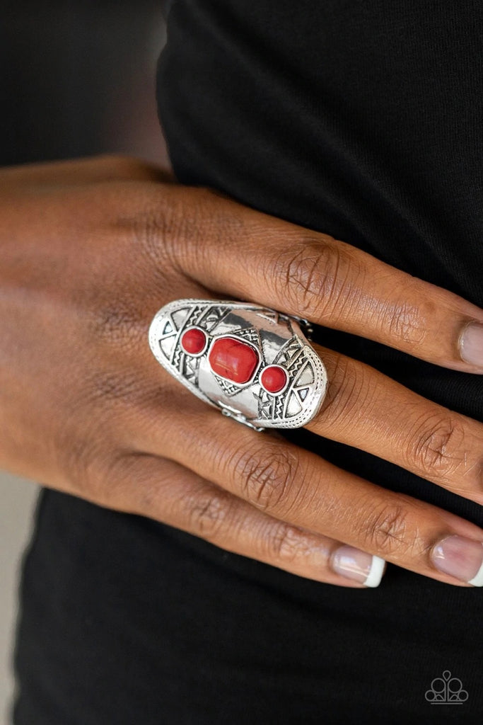 Three dainty red stones dot the center of an ornate silver frame stamped and embossed in tribal inspired patterns for a seasonal look. Features a stretchy band for a flexible fit.  Sold as one individual ring.