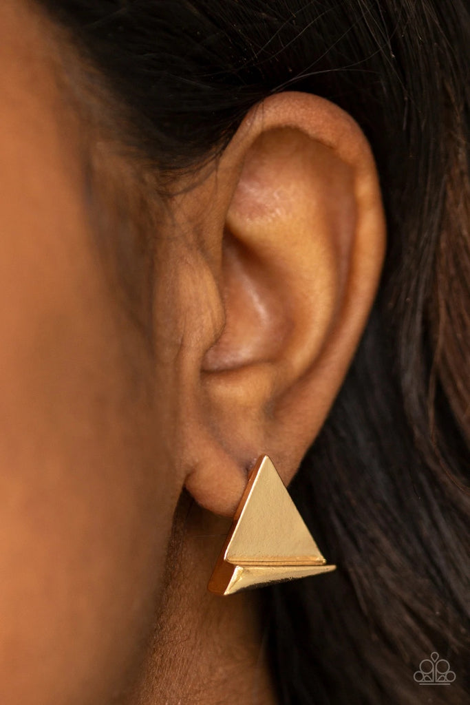 An angular frame is pressed into the bottom of a flat gold triangle, coalescing into an edgy frame. Earring attaches to a standard post fitting.  Sold as one pair of post earrings.