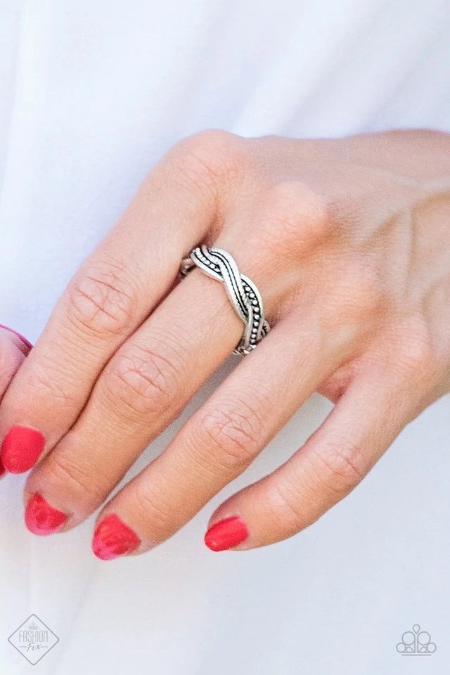 Featuring mismatched textures, ribbons of antiqued silver bands braid across the finger for a tribal inspired look. Features a dainty stretchy band. Sold as one individual ring.