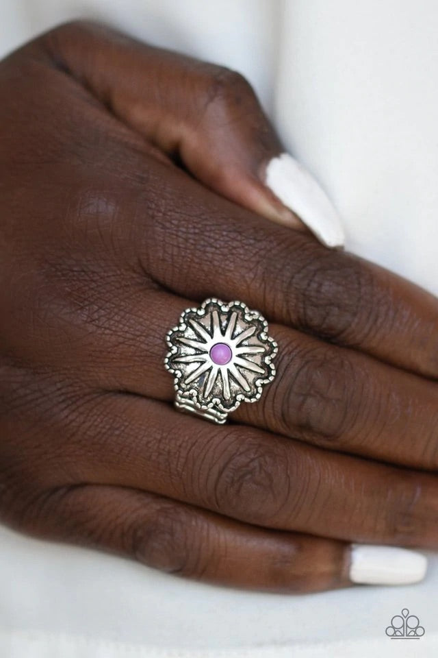 A dainty purple stone bead is pressed into the center of an antiqued silver frame radiating with floral detail for a seasonal flair. Features a stretchy band for a flexible fit. Sold as one individual ring.
