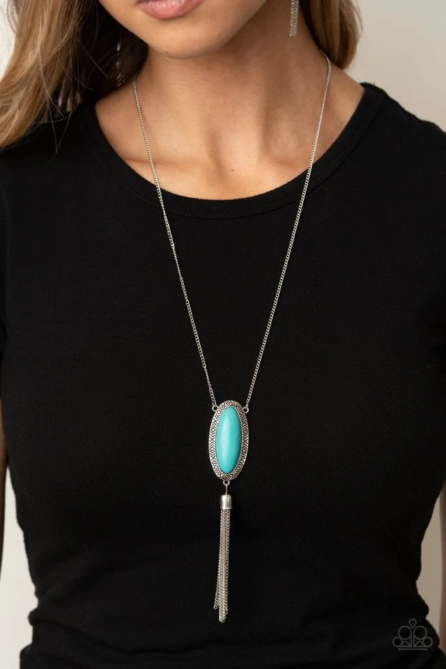 An oval turquoise stone is pressed into a glistening silver frame stamped in antiqued tribal inspired patterns. A shimmery silver chain tassel swings from the bottom of the earthy pendant for a whimsical finish. Features an adjustable clasp closure.  Sold as one individual necklace. Includes one pair of matching earrings.