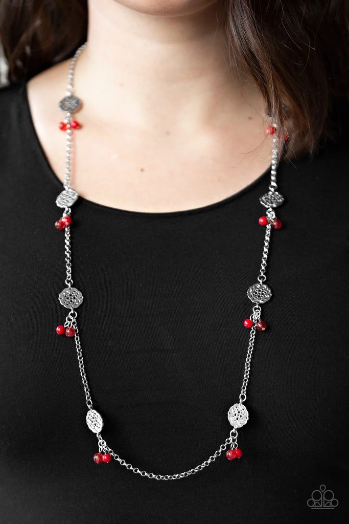 Featuring glassy and polished finishes, dainty red beads join ornate silver frames along a shimmery silver chain for a whimsical look. Features an adjustable clasp closure.  Sold as one individual necklace. Includes one pair of matching earrings.