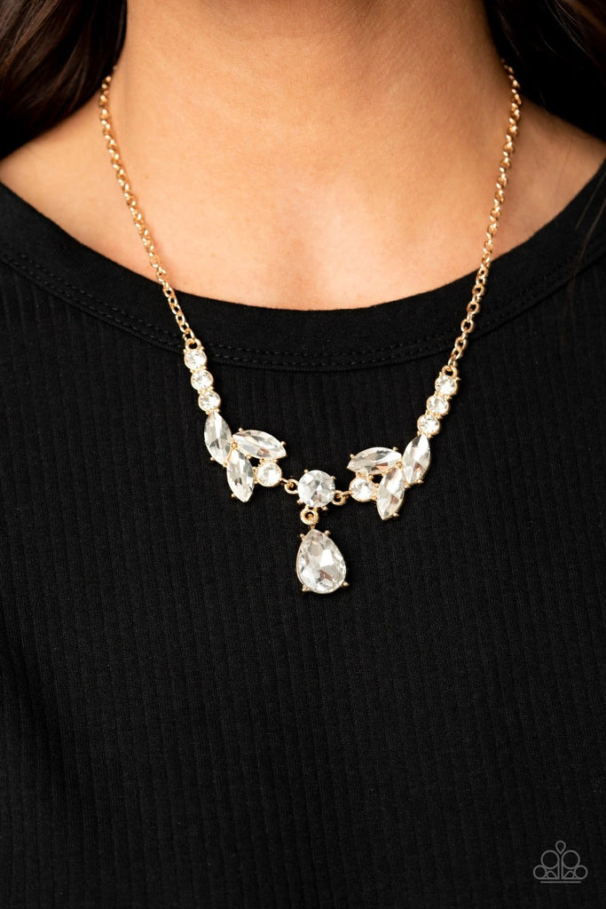 Tiers of white rhinestone encrusted gold frames delicately link below the collar, giving way to an oversized white teardrop rhinestone pendant for a timeless finish. Features an adjustable clasp closure.  Sold as one individual necklace. Includes one pair of matching earrings.