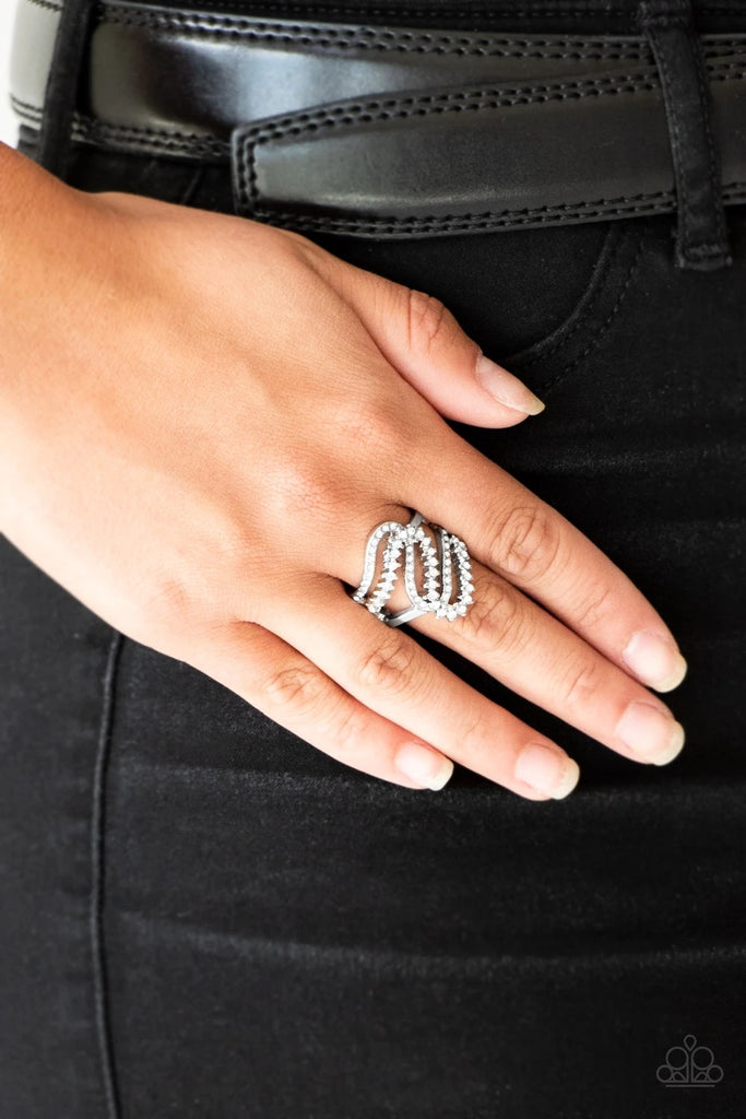 Encrusted in dainty white rhinestones, radiant silver ribbons wave across the finger, coalescing into a whimsical band. Features a stretchy band for a flexible fit.  Sold as one individual ring.