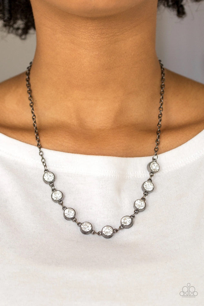 Encased in studded gunmetal frames, glittery white rhinestones link below the collar for a glamorous look. Features an adjustable clasp closure.  Sold as one individual necklace. Includes one pair of matching earrings.
