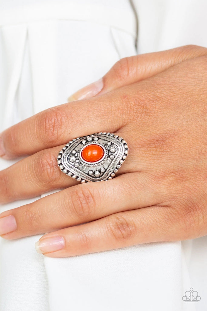A hearty orange bead is pressed into the center of a thick silver frame radiating with studded texture for a bold tribal look. Features a stretchy band for a flexible fit.  Sold as one individual ring.