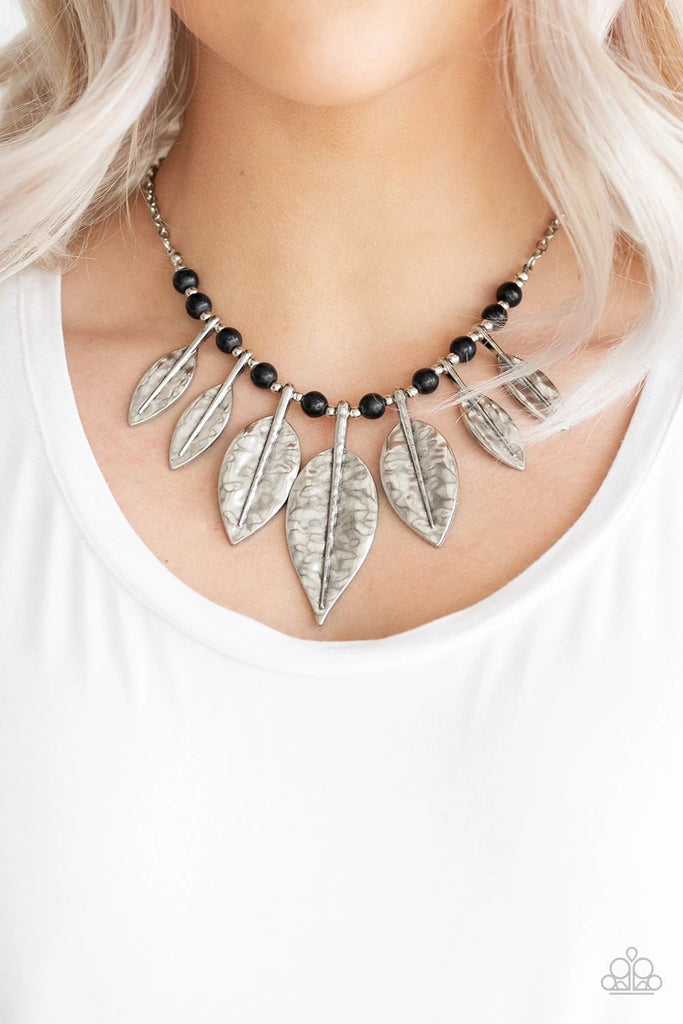 Featuring lifelike detail, hammered silver leaf frames are threaded along an invisible wire below the collar. Infused with dainty silver and earthy black stone beads, the leafy frames gradually increase in size for an artisan inspired finish. Features an adjustable clasp closure.  Sold as one individual necklace. Includes one pair of matching earrings.