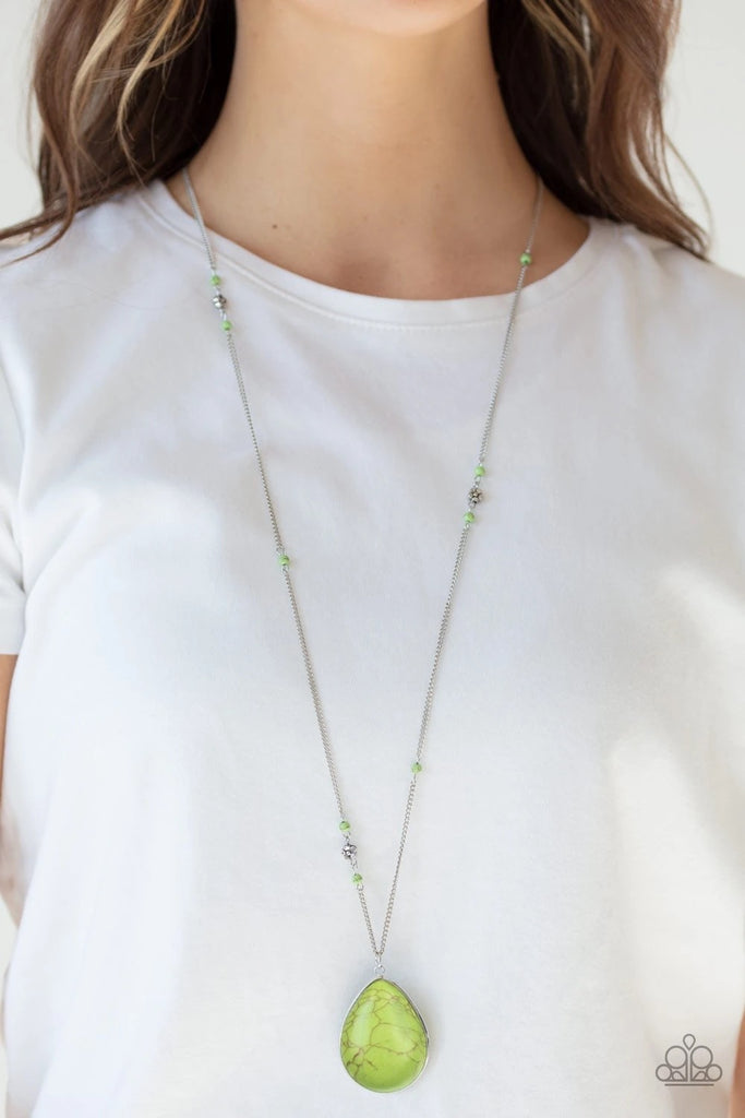 Dotted with dainty silver flowers and green stone beads, a shimmery silver chain gives way to an oversized green stone teardrop pendant for a whimsical look. Features an adjustable clasp closure.  Sold as one individual necklace. Includes one pair of matching earrings.