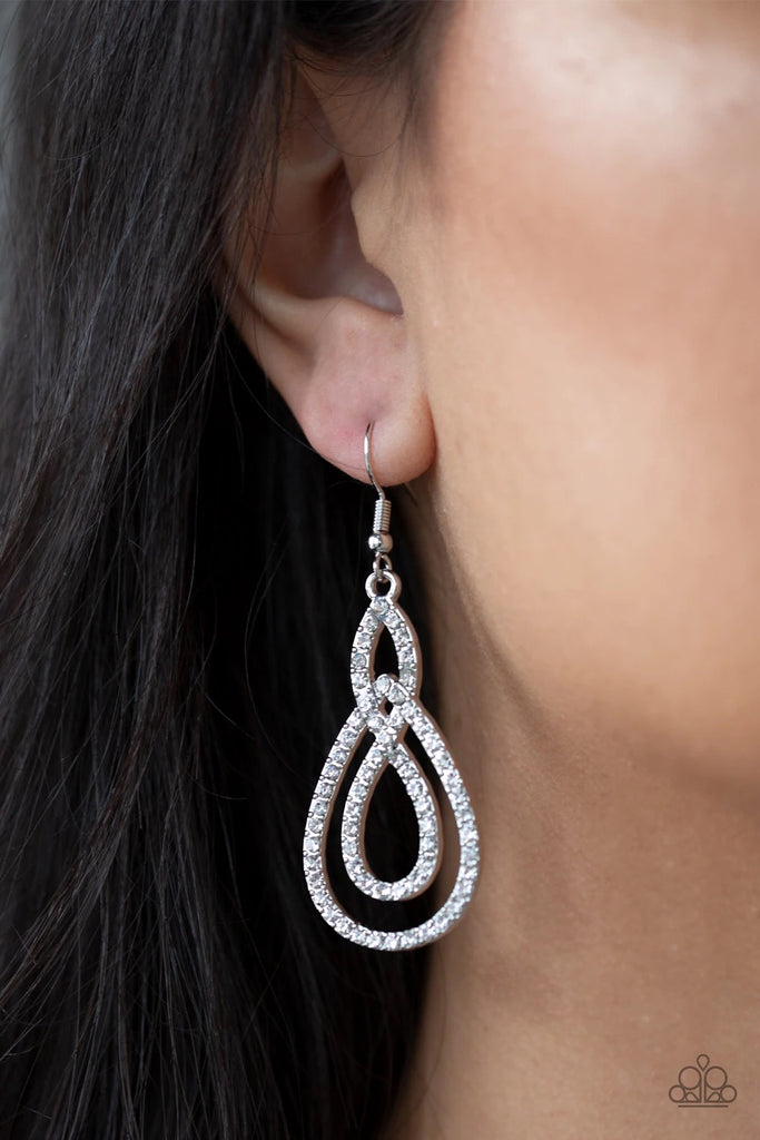 Encrusted in glassy white rhinestones, ribbons of shimmery silver loop into an elegant lure for a timeless look. Earring attaches to a standard fishhook fitting.  Sold as one pair of earrings.  