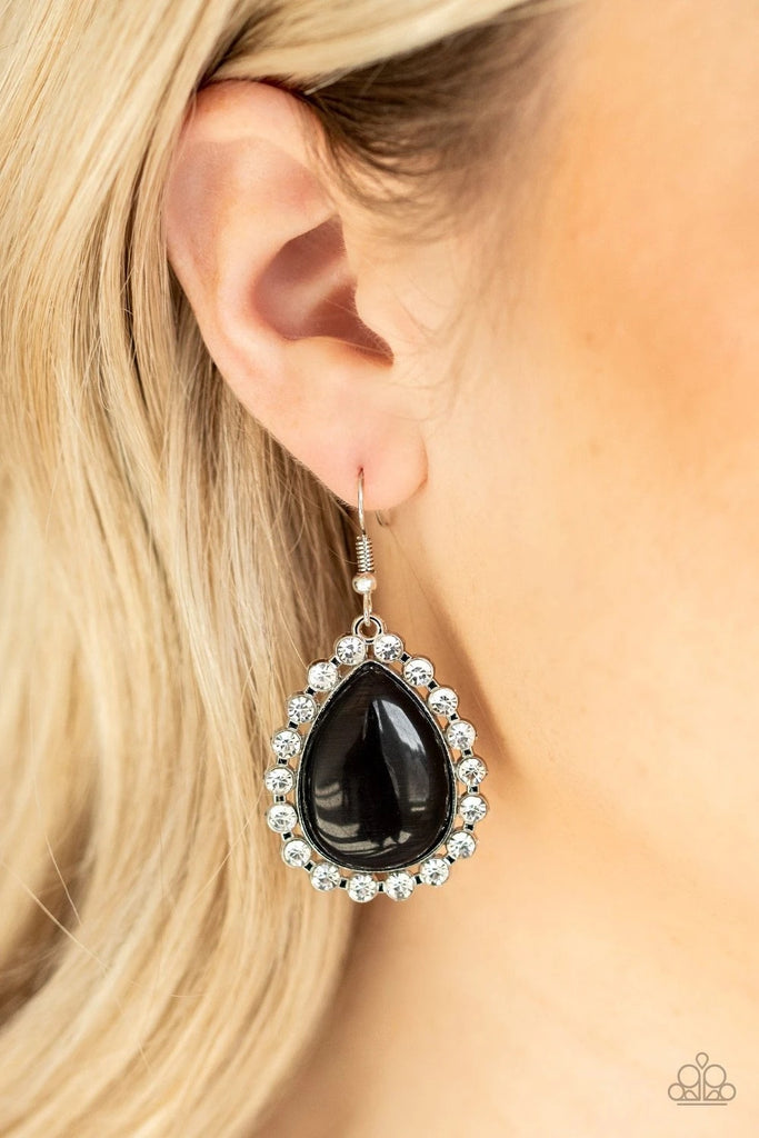 Glassy white rhinestones encircle a glowing black cat's eye stone teardrop, creating an elegant frame. Earring attaches to a standard fishhook fitting.  Sold as one pair of earrings.