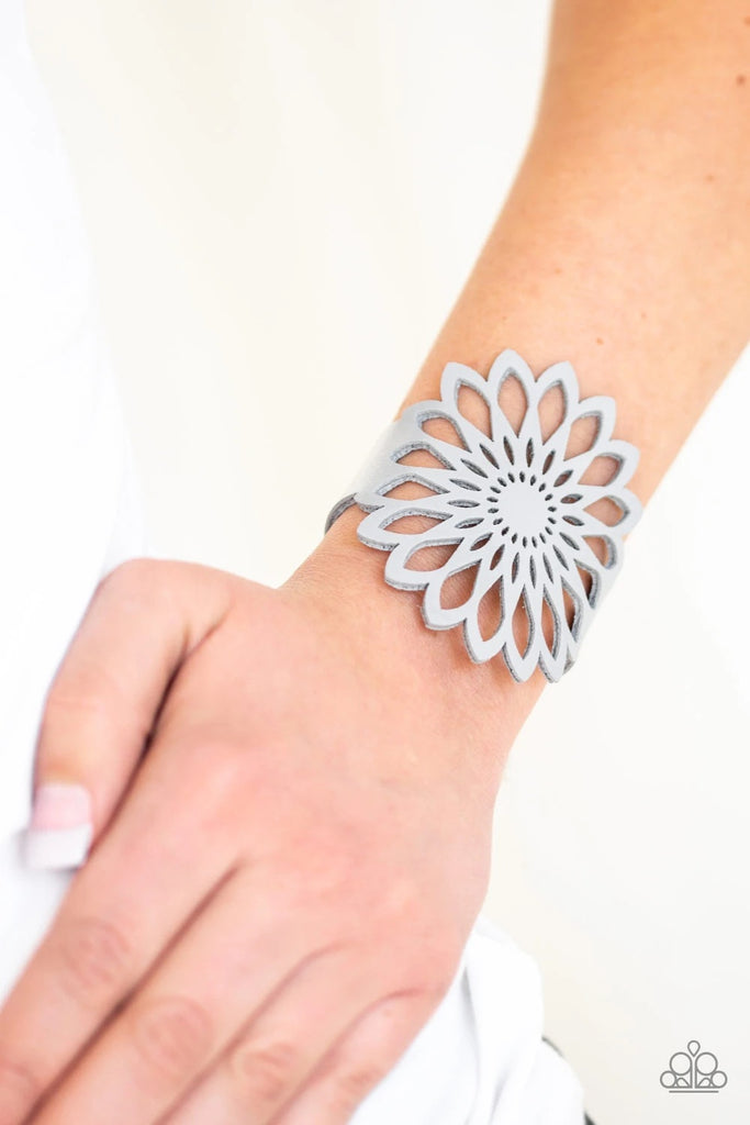 Stenciled in an airy wildflower pattern, a shiny gray leather band wraps around the wrist for a bold and colorful look. Features an adjustable clasp closure.  Sold as one individual bracelet.