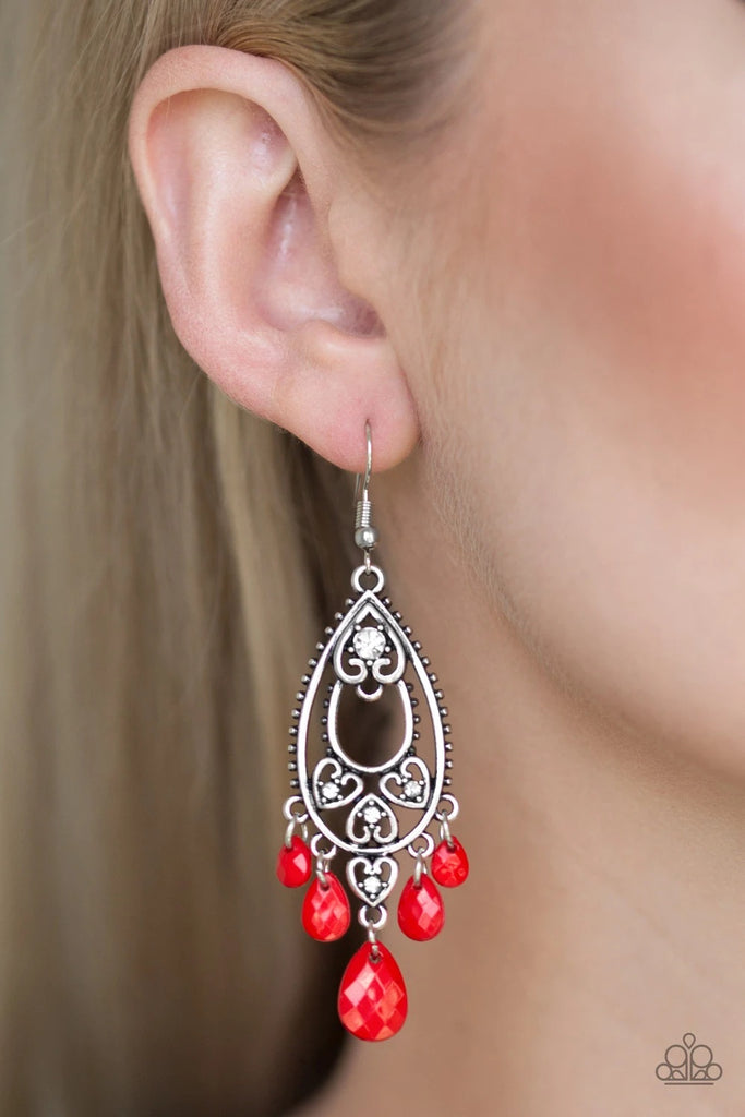 Radiating with white rhinestone centers, shimmery silver heart frames climb a silver teardrop, creating a whimsical lure. Faceted red teardrops swing from the bottom, adding a flirty fringe to the playful palette. Earring attaches to a standard fishhook fitting.  Sold as one pair of earrings.
