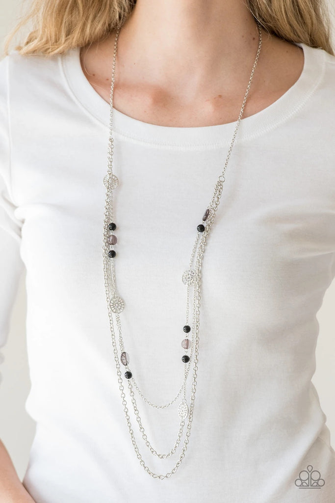 Ornate silver accents, glassy beads, and polished black beads trickle along strands of shimmery silver chains for a whimsical look. Features an adjustable clasp closure.  Sold as one individual necklace. Includes one pair of matching earrings.