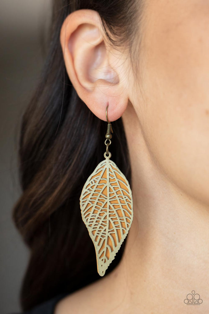 An airy stenciled brass leaf frame delicately overlaps with a brown metal leaf, creating a simply seasonal lure. Earring attaches to a standard fishhook fitting.  Sold as one pair of earrings.