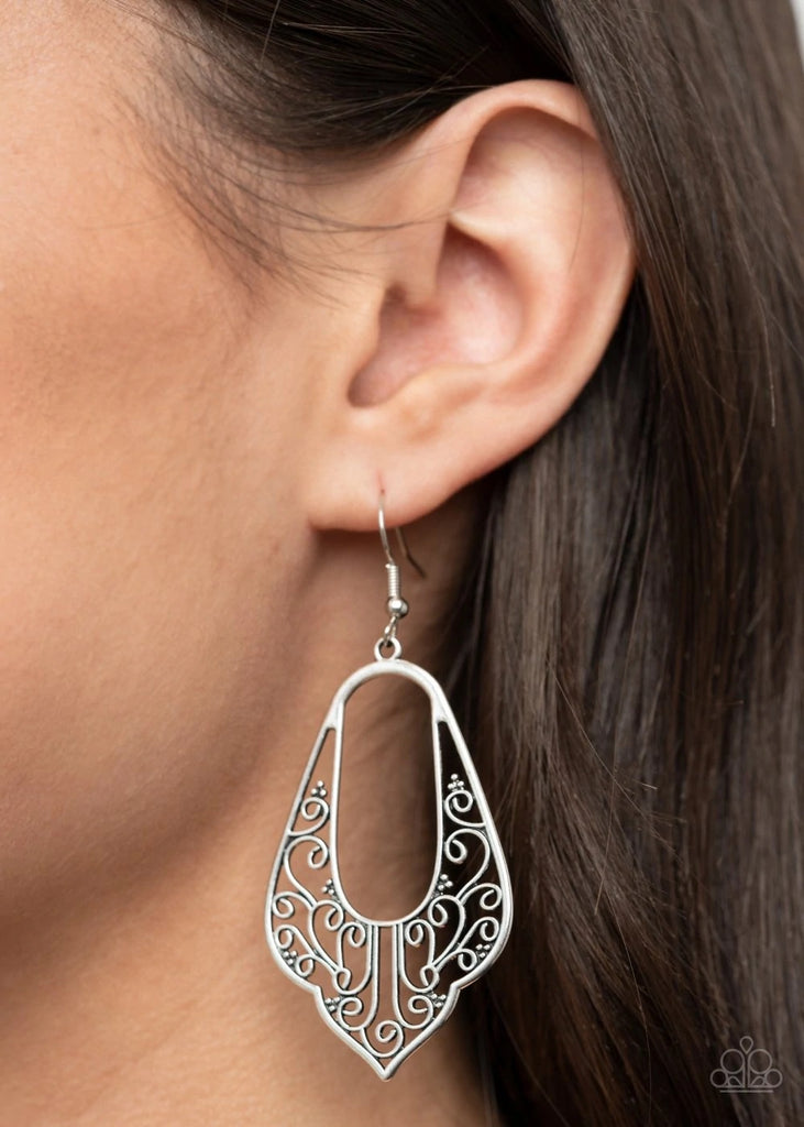 Silver vine-like filigree climbs the bottom of a scalloped silver frame, coalescing into a vintage inspired look. Earring attaches to a standard fishhook fitting.  Sold as one pair of earrings.