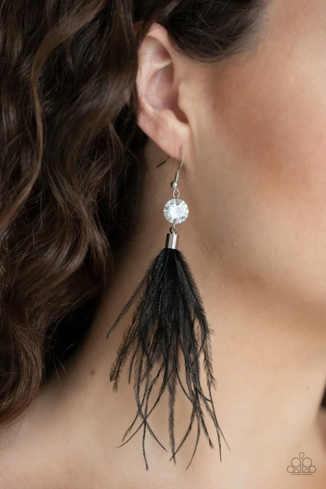 Fuzzy black feathers swing from the bottom of an oversized white rhinestone, creating a refined lure. Earring attaches to a standard fishhook fitting.  Sold as one pair of earrings.