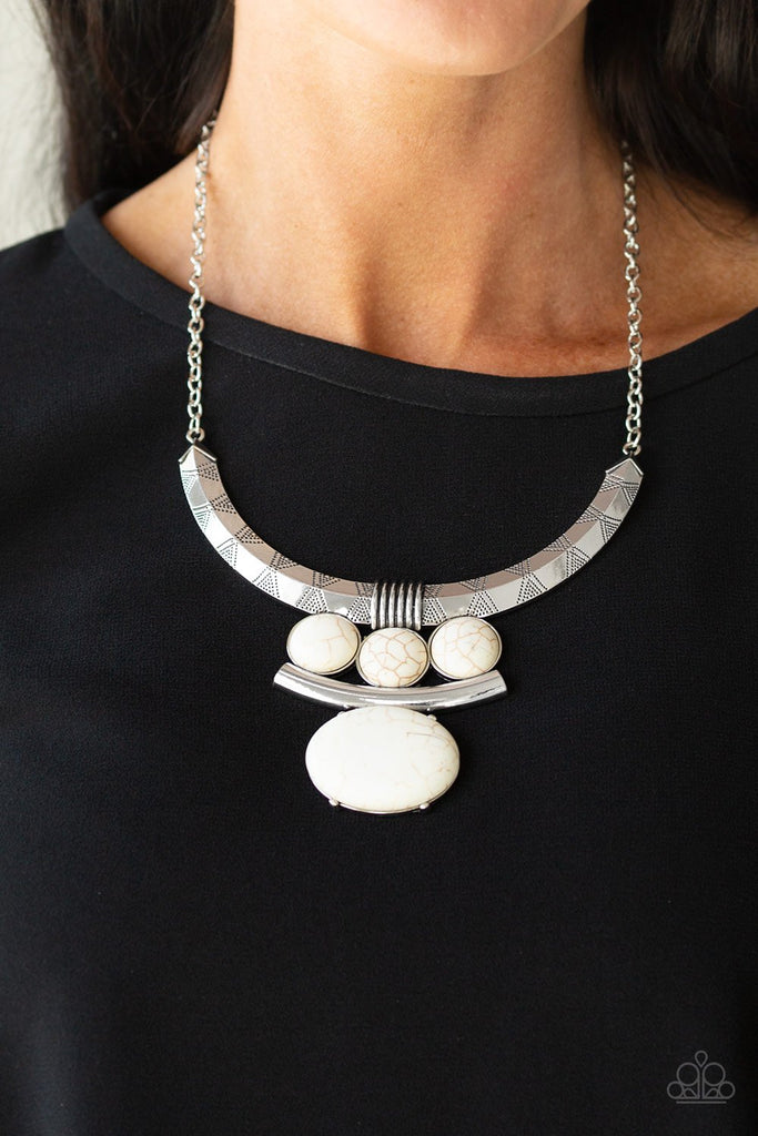 Oversized white stone accents alternate with mismatched silver frames, coalescing into a dramatic tribal inspired pendant below the collar. Features an adjustable clasp closure.  Sold as one individual necklace. Includes one pair of matching earrings.