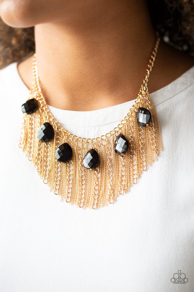 Infused with a row of faceted black teardrops, mismatched strands of gold chains stream from the bottom of a glistening gold chain, creating a statement-making fringe below the collar. Features an adjustable clasp closure. Sold as one individual necklace. Includes one pair of matching earrings.