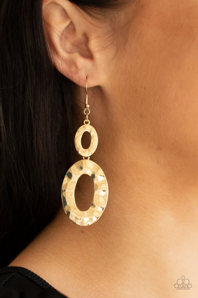 A mismatched pair of hammered gold ovals delicately link into a blinding metallic lure. Earring attaches to a standard fishhook fitting.  Sold as one pair of earrings.