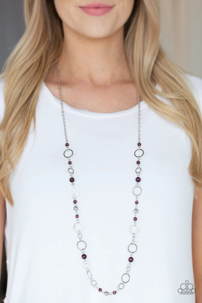 Shimmery silver hoops and glowing purple moonstone beads connect into a whimsical chain across the chest. Features an adjustable clasp closure.  Sold as one individual necklace. Includes one pair of matching earrings.