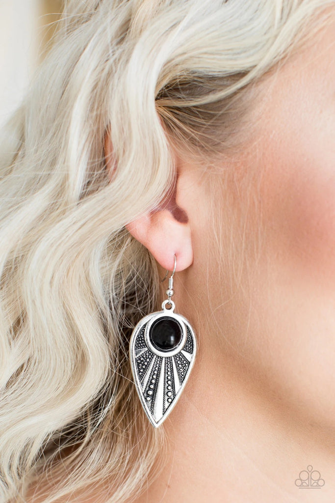 A polished black bead is pressed into the top of an ornate silver teardrop radiating with studded textures for a tribal inspired look. Earring attaches to a standard fishhook fitting.  Sold as one pair of earrings.