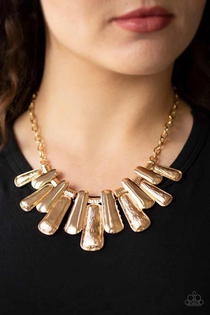 Featuring smooth and etched finishes, a collection of glistening gold plates link below the collar, creating a blinding fringe. Features an adjustable clasp closure.  Sold as one individual necklace. Includes one pair of matching earrings.