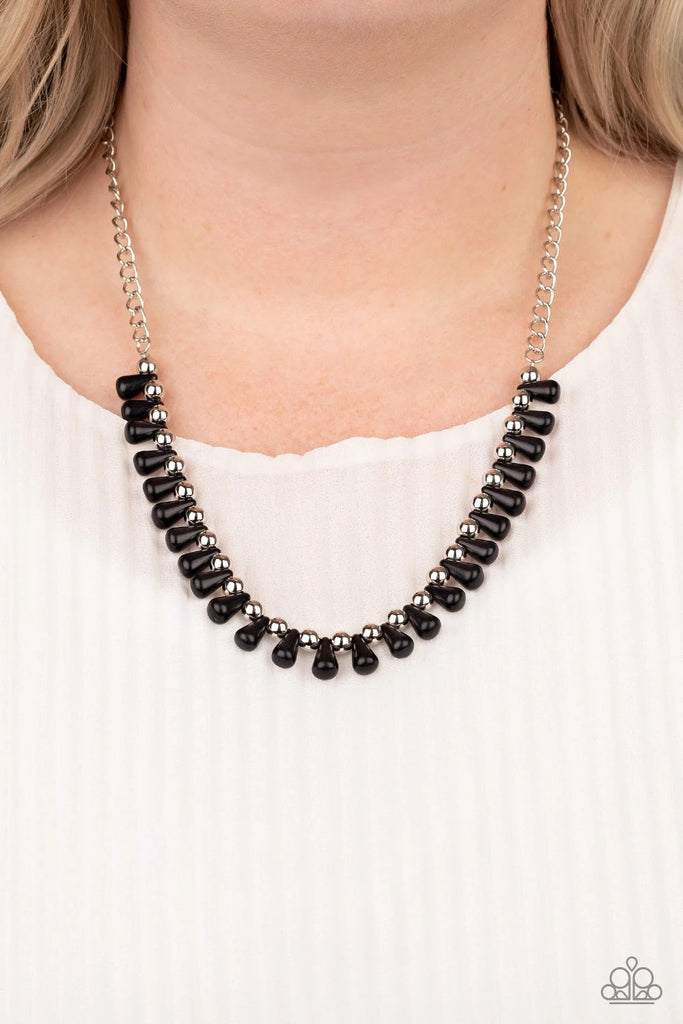 Black teardrop stones and classic silver beads are threaded along an invisible wire. The earthy beads alternate below the collar, creating a wild fringe. Features an adjustable clasp closure.  Sold as one individual necklace. Includes one pair of matching earrings.