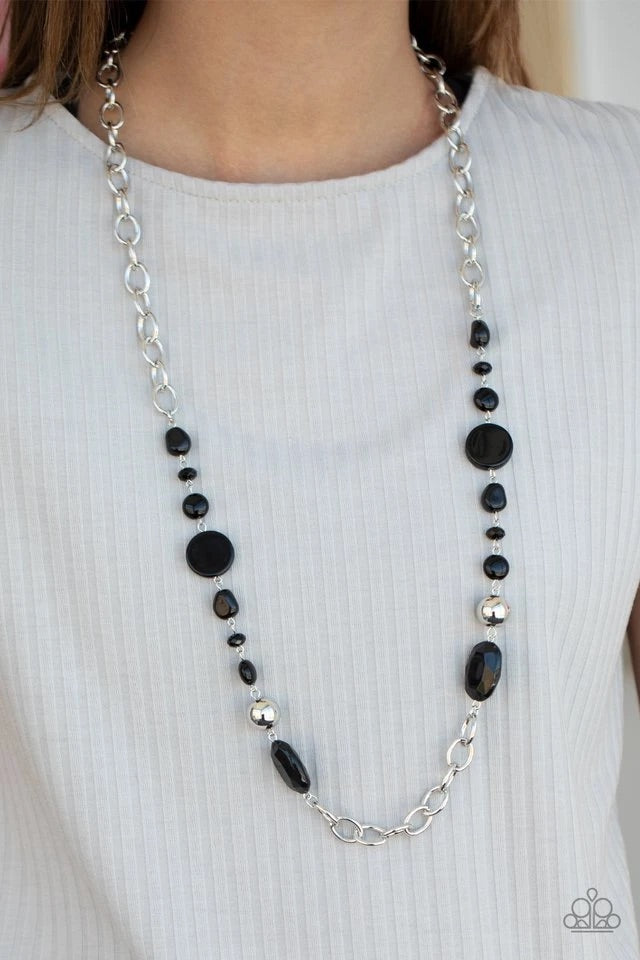 Varying in size and shape, flat and faceted black beads link with a pair of classic silver beads along sections of bold silver links, coalescing into a colorful display across the chest. Features an adjustable clasp closure.  Sold as one individual necklace. Includes one pair of matching earrings.