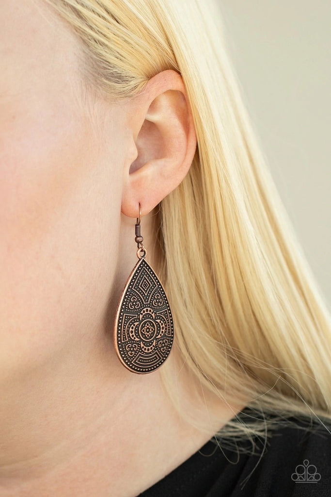 Studded in a decorative floral pattern, an antiqued copper teardrop swings from the ear in a trendy tribal fashion. Earring attaches to a standard fishhook fitting.  Sold as one pair of earrings.