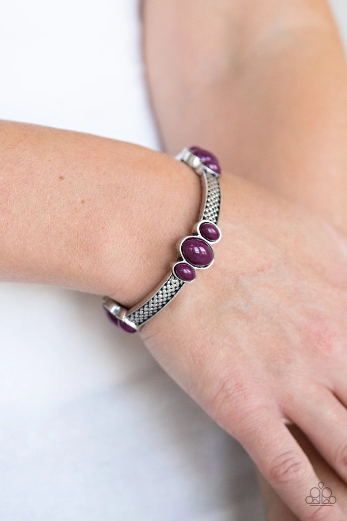 Trios of bubbly plum beads are attached to the top of textured silver bars, coalescing into decorative frames. The colorful frames are threaded along stretchy bands around the wrist for a trendy pop of color.  Sold as one individual bracelet.