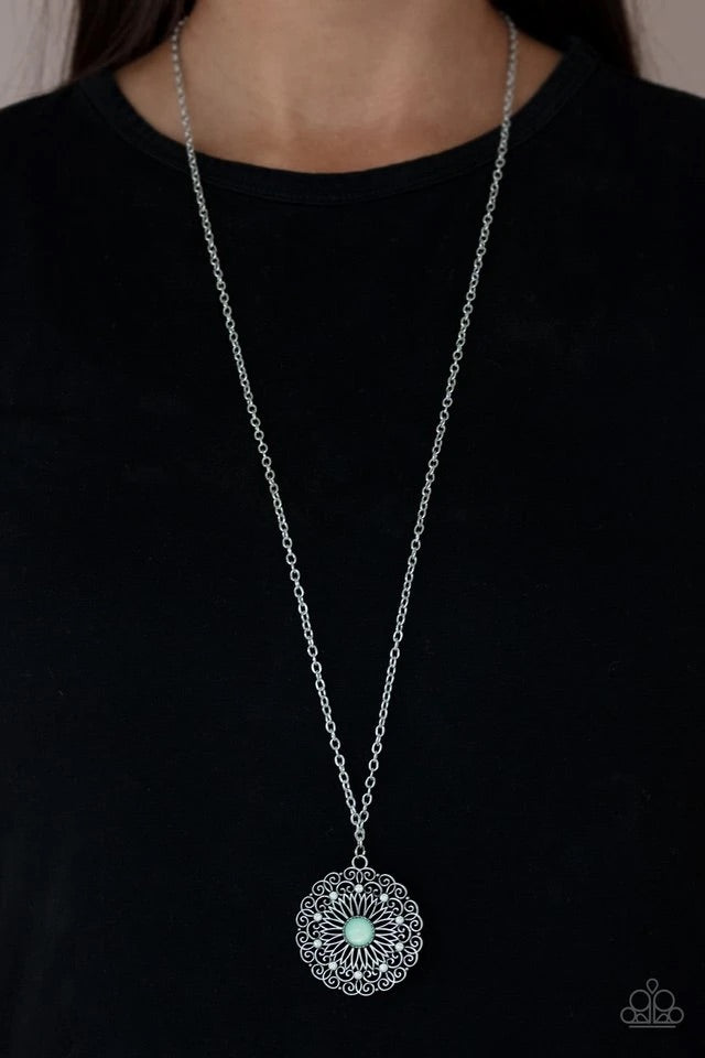 Dotted in dainty opalescent beads, stacks of whimsical silver petals bloom from a Green Ash beaded center, creating a decorative floral pendant at the bottom of a lengthened silver chain. Features an adjustable clasp closure.  Sold as one individual necklace. Includes one pair of matching earrings.