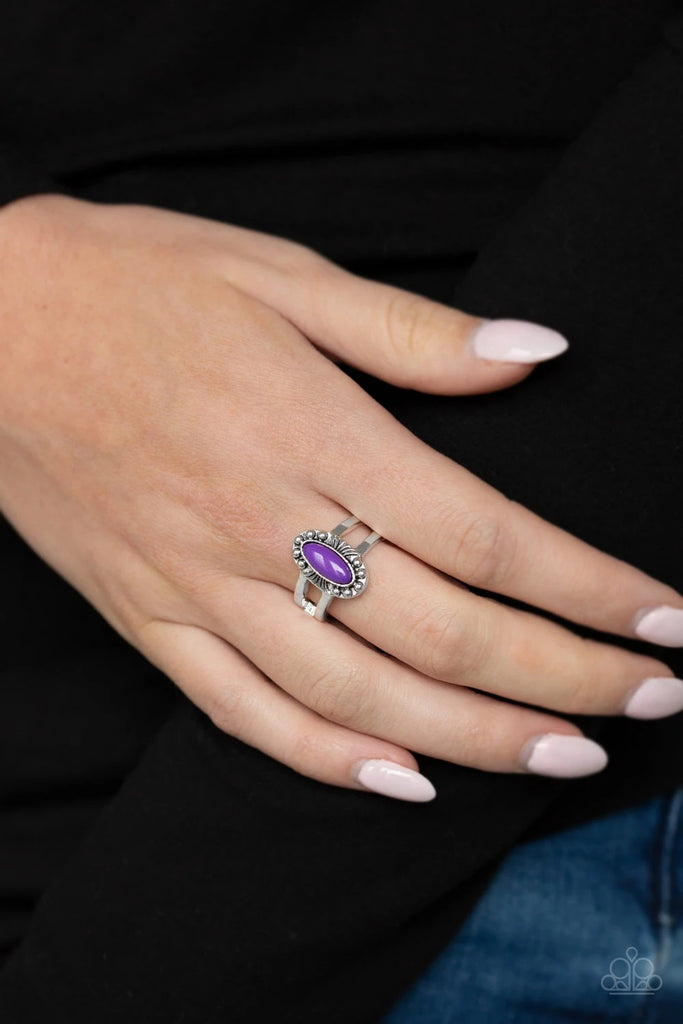 Featuring an edgy marquise shape, a vivacious purple bead is pressed into a dainty silver frame radiating with studded and wispy linear patterns for a colorful tribal look. Features a dainty stretchy band for a flexible fit.  Sold as one individual ring.  
