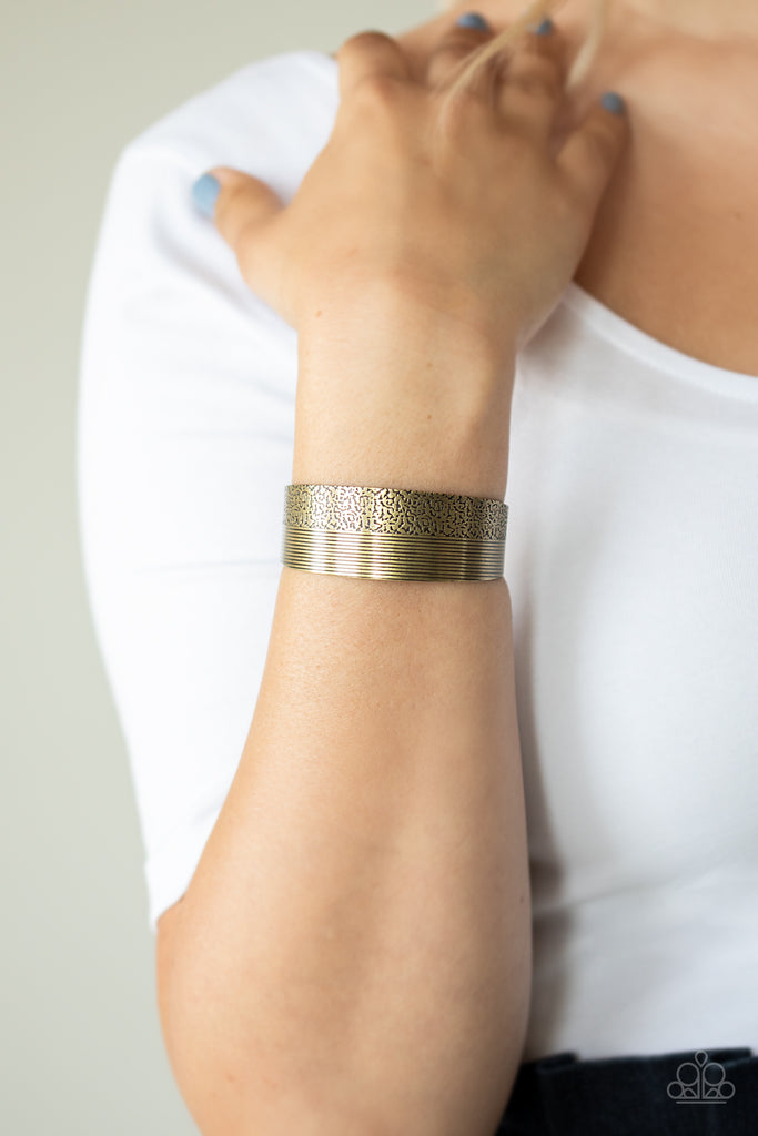 One half of a thick brass cuff is engraved in stacked linear lines while the other half is hammered in a row of tactile textures, creating a collision of texture around the wrist.  Sold as one individual bracelet.