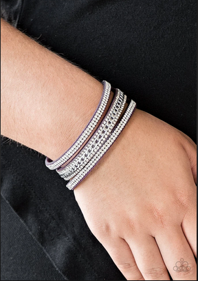 Rows of glassy white rhinestones and a shimmery silver chain are encrusted along vibrant purple suede bands for a sassy look. Features an adjustable snap closure.  Sold as one individual bracelet.