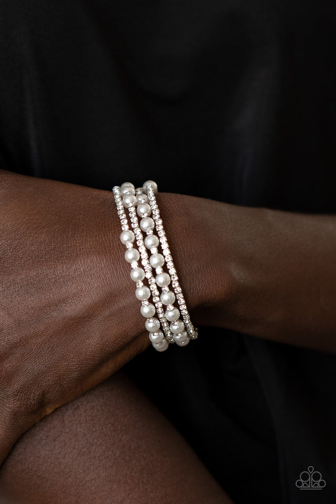 Row after row of glassy white rhinestones and classic white pearls coil around the wrist, creating a blinding infinity wrap bracelet.  Sold as one individual bracelet.  Life of the Party