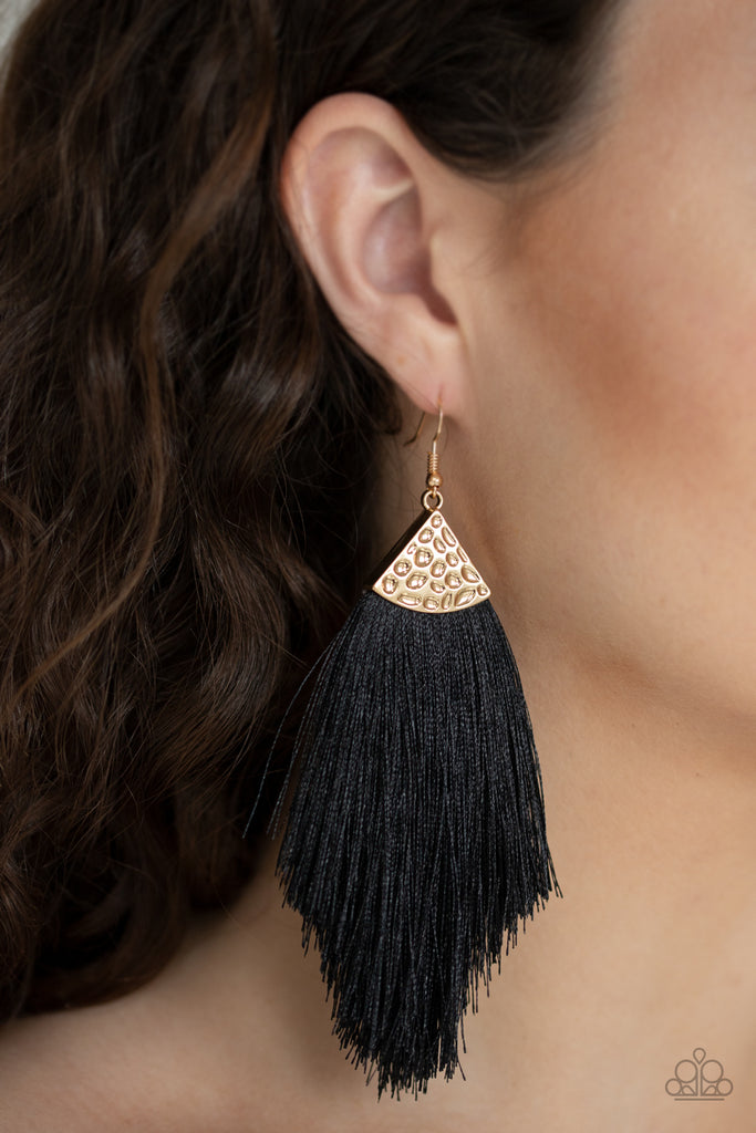 Shiny black thread fans out from the bottom of a hammered gold fitting, creating a tapered fringe. Earring attaches to a standard fishhook fitting.  Sold as one pair of earrings.