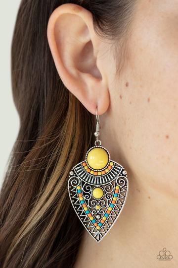 Blue, orange, and yellow beads decorate the front of a spade shaped silver frame radiating with linear and zigzagging details for a tribal inspired look. Earring attaches to a standard fishhook fitting.  Sold as one pair of earrings.