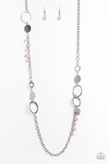 Infused with sections of shimmery silver chains, an assortment of hammered silver discs and silver rings link across the chest. A collection of pearly pink beads and dainty silver heart charms asymmetrically dot the glistening piece for a flirty finish. Features an adjustable clasp closure.  Sold as one individual necklace. Includes one pair of matching earrings.